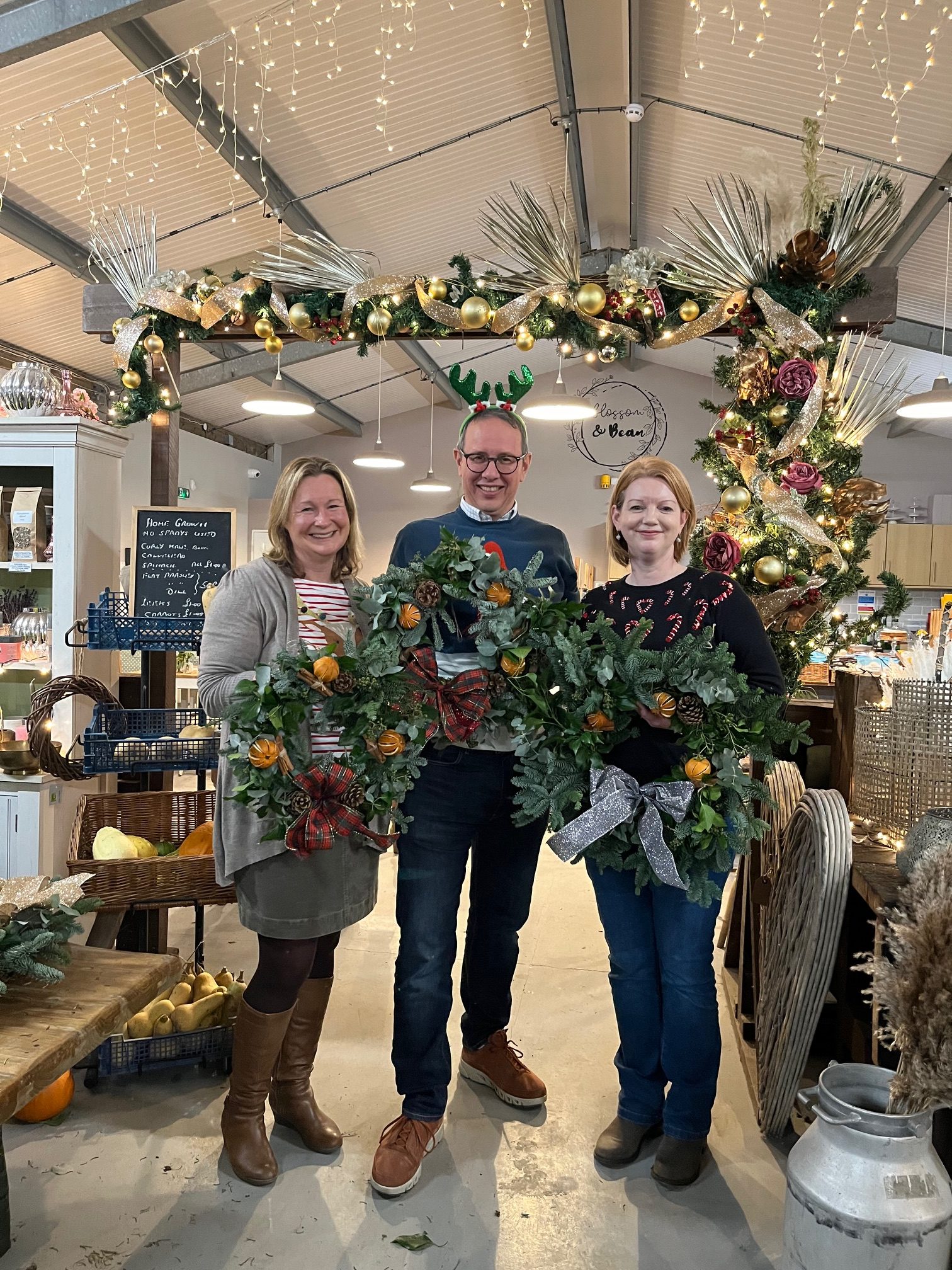 Hughes Solicitors partners holding Christmas wreaths